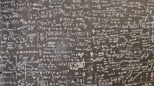 Variables and equations written on paper